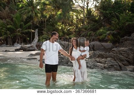 Happy Smile European Family Have Rest And Run On White Sand Beach