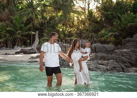 Happy Smile European Family Have Rest And Run On White Sand Beach