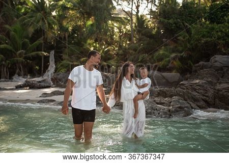 Happy Smile European Family Have Rest And Run On White Sand Beach