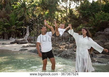 Happy Smile European Family Have Rest And Run On White Sand Beach