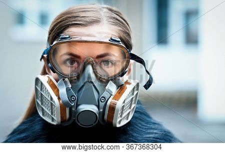 Young Woman Wearing Full Face Respirator Protective Mask And Goggles, Extreme Coronavirus Protection