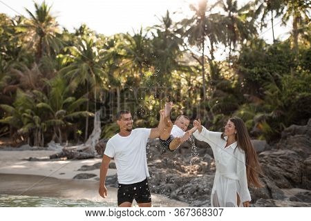 Happy Smile European Family Have Rest And Run On White Sand Beach