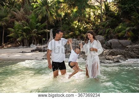 Happy Smile European Family Have Rest And Run On White Sand Beach