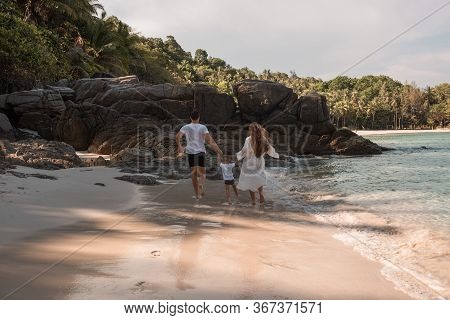 Happy Smile European Family Have Rest And Run On White Sand Beach. Father, Long Black Chestnut Hair