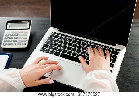 Crop Of Womens Hands Lying On The Keyboard Of A Laptop Among The Office Premises. The Concept Of Rem