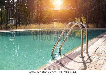 Big Luxury Empty Rectangular Swimming Pool With Clean Blue Water And Ladder At Tropical Forest Beach