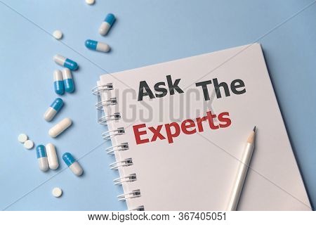 White Card Sign With Ask An Expert Text Message With Medical Pills