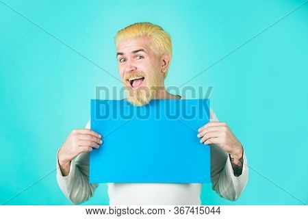 Smiling Man Holding Empty Blank Board. Caucasian Blond Male Model Posing In Fashion Concept Studio S