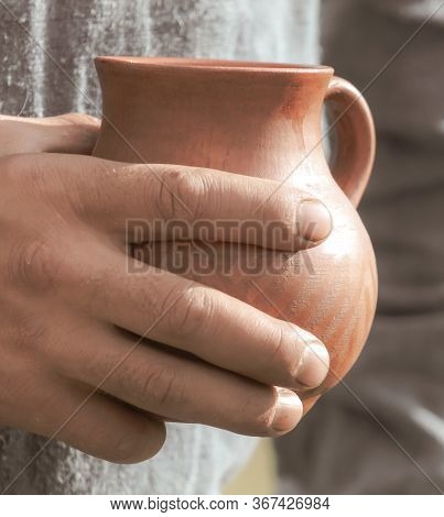 A Man With Clay Jugs In His Hand. Antique Dishes