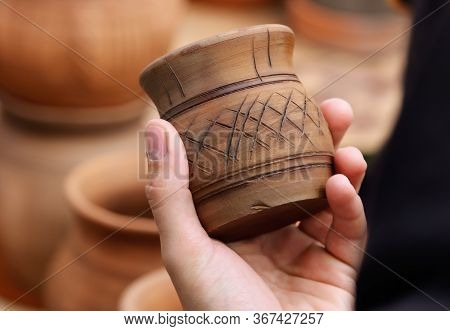 A Man With Clay Jugs In His Hand. Antique Dishes