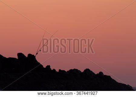 Ibarrangelu, Bizkaia/basuqe Country; Sept. 26, 2015. Two Fishing Rods On The Rocks By The Ocean At S