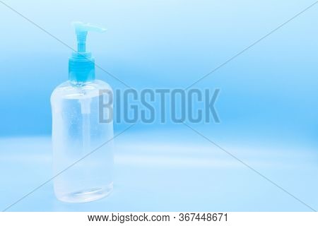 Clear Hand Sanitizer Keychain Isolated On A Blue Background.