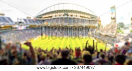 Fans In Full Stadium Celebrate There Goal In Open Air Roof Stadium In Summer.  -blurred Technique.