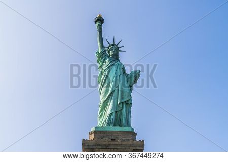 The Statue Of Liberty  With Blue Sky Background.