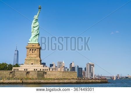 The Statue Of Liberty  With Blue Sky Background.
