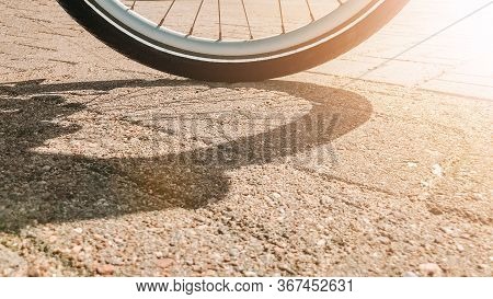 The Wheel Of A Walking Bicycle With A Black Tire And A White Stripe And A Silver Rim And Spokes Stan