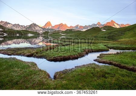 Wetland With Winding Brooks At Lacs De Fenetre With Reflection At Sunrise And Grand Jorasses; Val Fe