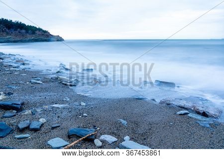 Storm Surges At Slow Shutter Speeds On A Pebble-sandy Beach, The Resort Of Gelendzhik, The Twilight.