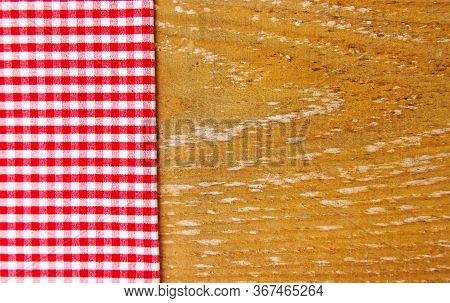 Red Cotton Napkin In A Cage Side View On A Wooden Table