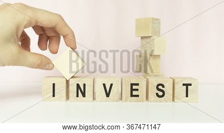 Word Invest On Wooden Cubes, Informative And Communication Background