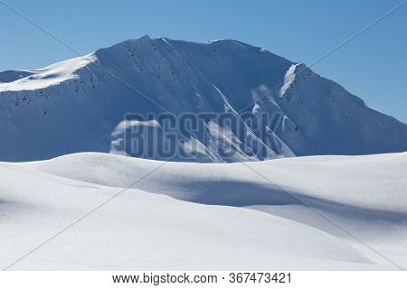 Snow Covered Sandhubel Mountain Summit Near Arosa In Winter, Blue Sky And Sunshine