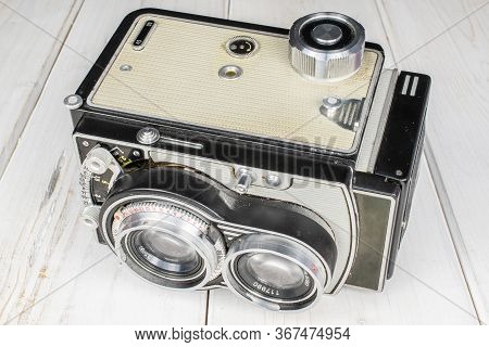 One Whole Light Vintage Camera On White Wood