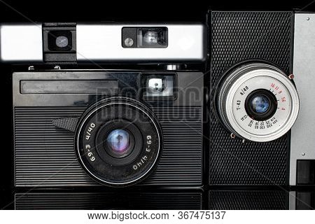 Group Of Three Whole Vintage Camera Closeup Isolated On Black Glass