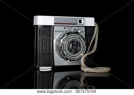 One Whole Vintage Camera One Lens Isolated On Black Glass