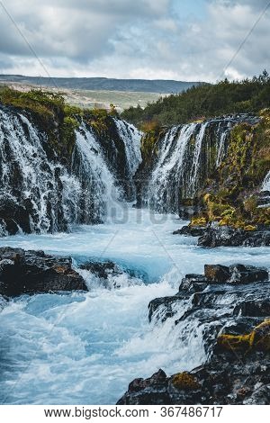 Dramatic Views Of The Bright Powerful Bruarfoss Bluw Waterfall. Popular Tourist Attraction. Blue Sky