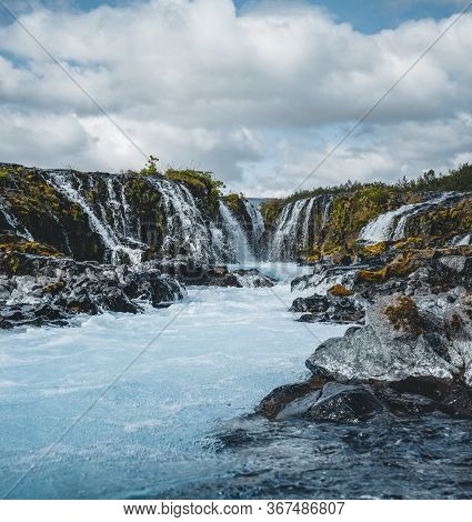 Dramatic Views Of The Bright Powerful Bruarfoss Bluw Waterfall. Popular Tourist Attraction. Blue Sky