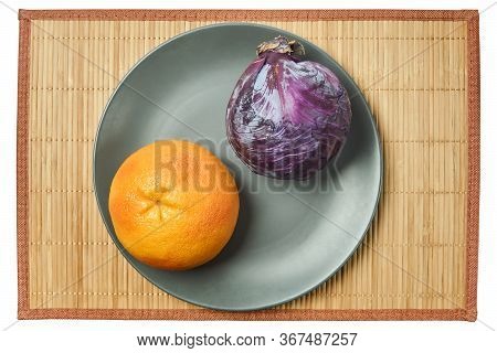 Color Still Life - Purple Head Of Red Cabbage And Rosy Yellow Grapefruit On A Gray Plate On A Cane T