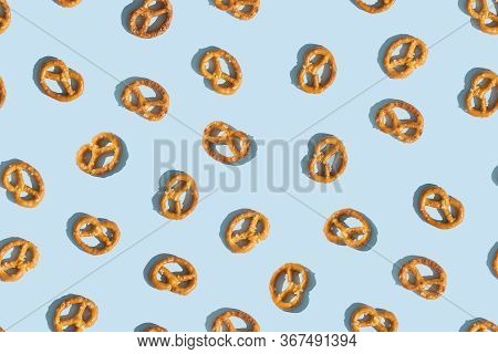 Crunchy Brezeln Or Salted Pretzel Trendy Pattern On Blue Background. Top View, Flat Lay. Traditional