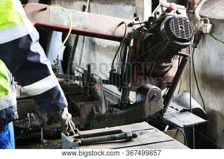 A Man Works On Old Equipment In A Factory. Old Equipment. Safe Work. Remote Control. Saw For Metal. 
