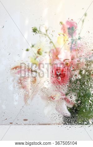 Beautiful Wallpeper Of A Flower Bouquet Standing Behind A Window Covered With Fresh Rain Drops