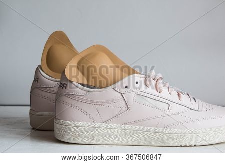 Pair Of Pink Running Shoes With Orthopedic Insoles. White Background.