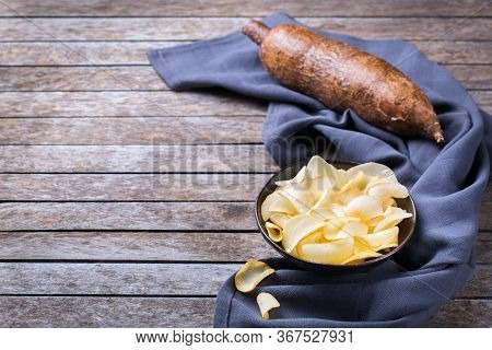 Brazilian Cuisine Food, Latin Snack. Yucca, Yuca, Cassava, Manioca Chips On A Table. Copy Space Back