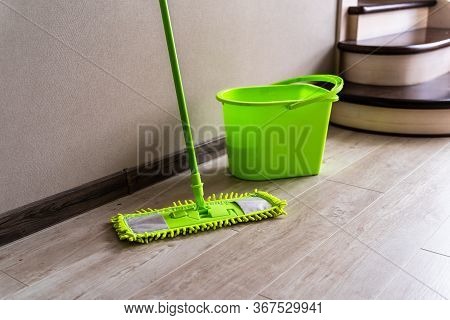 Mop With Green Microfiber Rag, Green Plastic Handle And Bucket. Housekeeping Concept.