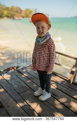 Fashion Child. Happy Boy Model. Stylish Little Boy In Baseball. Handsome Kid. White Sneakers. Red Ca