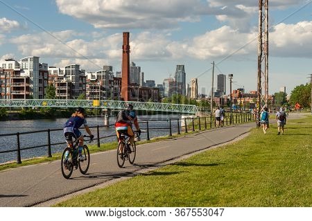 Montreal, Ca - 7 June 2019: Cyclists And Walkers Enjoying A Warm And Sunny Spring Day Along The Lach