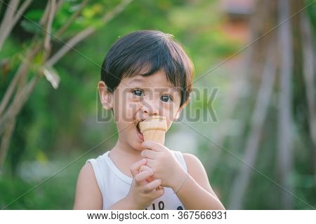 Asia Boy He Mouth Aftertaste From Eating Chocolate Ice Cream Or Chocolate Dessert. A Sweet-toothed C