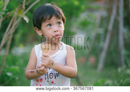 Asia Boy He Mouth Aftertaste From Eating Chocolate Ice Cream  Or Chocolate Dessert. A Sweet-toothed 
