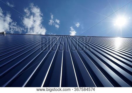 Factory Barrels In Industrial Areas With Aluminum As Outer Cladding Photographed In Summer