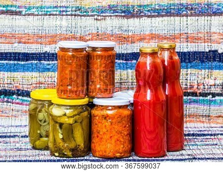 Glass Jars With Pickled Red Bell Peppers And Pickled Cucumbers (pickles) Isolated. Jars With Variety