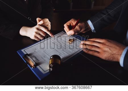 Divorce Process. Man And Woman Sign Documents Because Of Broke Up.