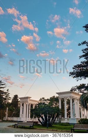Morning Sky With Small Clouds Over The White Colonades In The Park