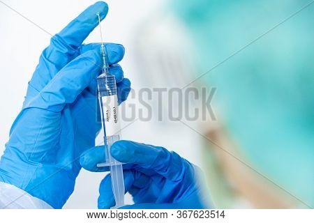 Doctor, Scientist, Researcher Hand In Blue Gloves Or Protective Suit Preparing For Human Clinical In
