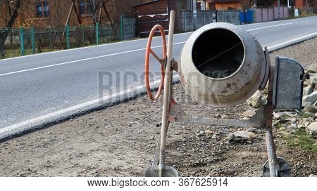 Gravity Mobile Concrete Mixer With Self-discharge Orange Color Prepares Cement Mortar. Mobile Constr