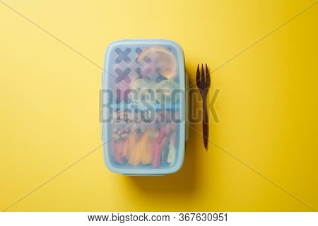 Top View of Full Lunch Box with Fuits, Vegetables and nuts.