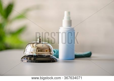 Cleaning Ringing Bell On Reception Desk. Disinfection Spray, Small Towel. Protection From Bacteria A