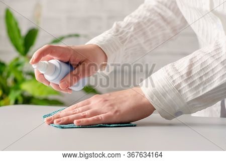 Hand Of Woman Cleaning Reception Desk. Disinfection Spray, Small Towel. Protection From Bacteria And